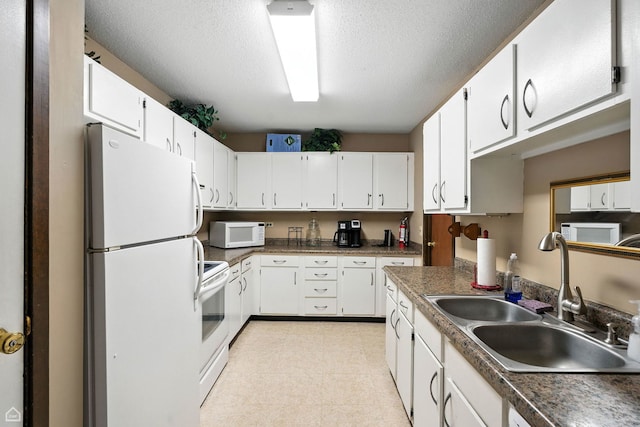 740 Saint Andrews Ln Unit 5, Crystal Lake, IL 60014 - kitchen featuring white appliances, white cabinetry, a textured ceiling, light floors, and dark countertops