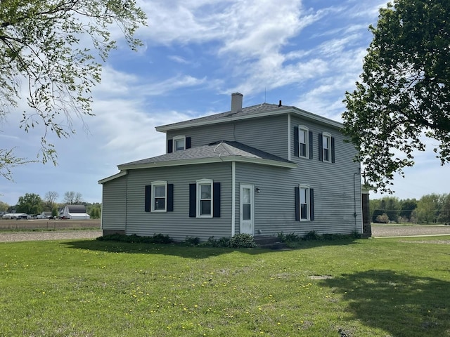 6808 S Oak Grove Rd, Harvard, IL 60033 - view of front of home with a chimney and a front lawn