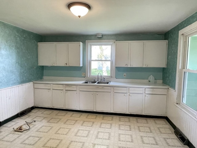 6808 S Oak Grove Rd, Harvard, IL 60033 - kitchen with light countertops, white cabinets, and light floors