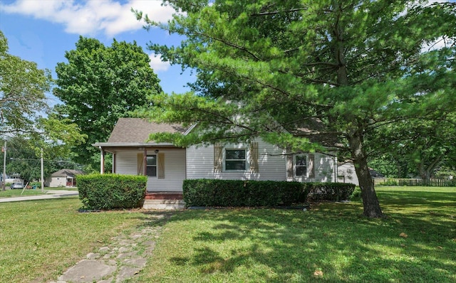1010 N Neil St, Champaign, IL 61820 - view of front of property featuring covered porch, a front lawn, and roof with shingles