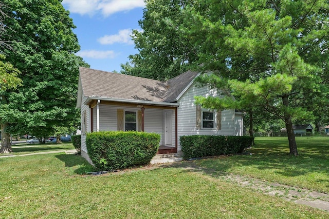 1010 N Neil St, Champaign, IL 61820 - bungalow-style home featuring a shingled roof and a front lawn