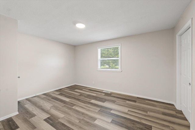 1010 N Neil St, Champaign, IL 61820 - unfurnished bedroom with wood finished floors and baseboards