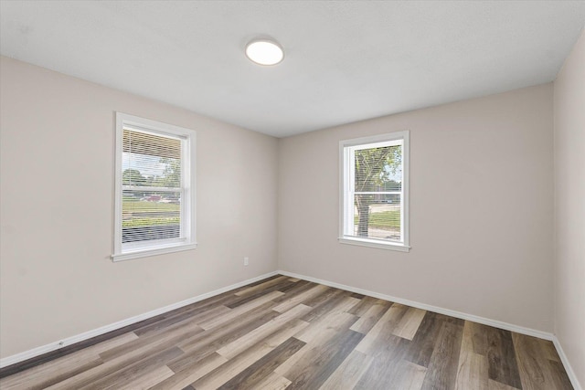 1010 N Neil St, Champaign, IL 61820 - empty room with wood finished floors and baseboards