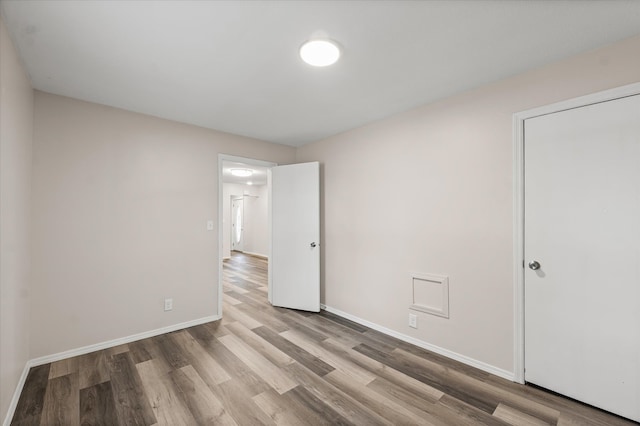1010 N Neil St, Champaign, IL 61820 - unfurnished bedroom with wood finished floors and baseboards