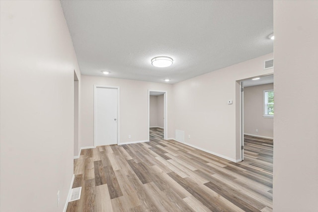 1010 N Neil St, Champaign, IL 61820 - spare room with light wood-style floors and a textured ceiling
