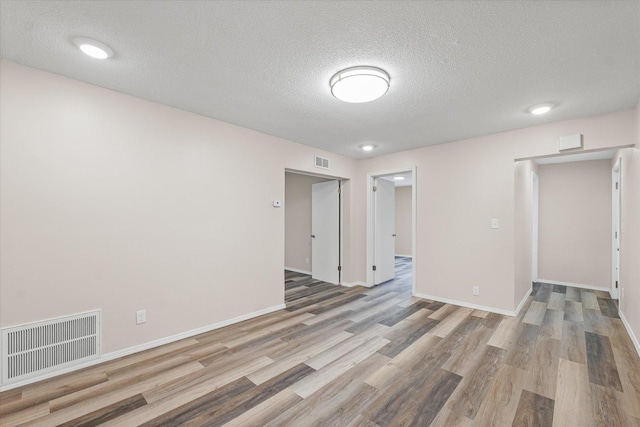 1010 N Neil St, Champaign, IL 61820 - empty room with wood finished floors and a textured ceiling
