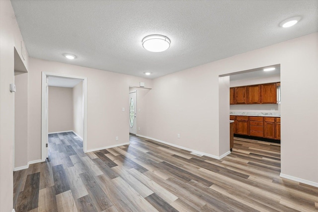 1010 N Neil St, Champaign, IL 61820 - unfurnished living room featuring wood finished floors and a textured ceiling