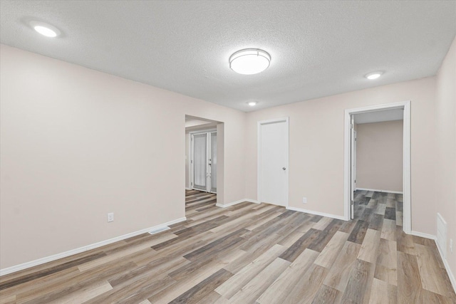 1010 N Neil St, Champaign, IL 61820 - unfurnished room with light wood-type flooring and a textured ceiling