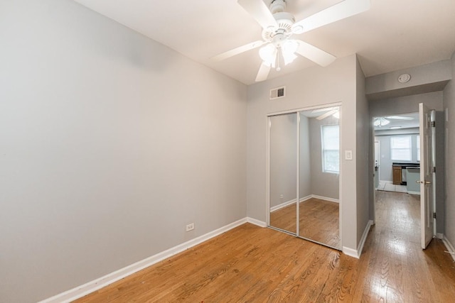 4008 W Nelson St Unit 8A, Chicago, IL 60641 - unfurnished bedroom featuring light wood-type flooring, a closet, and a ceiling fan
