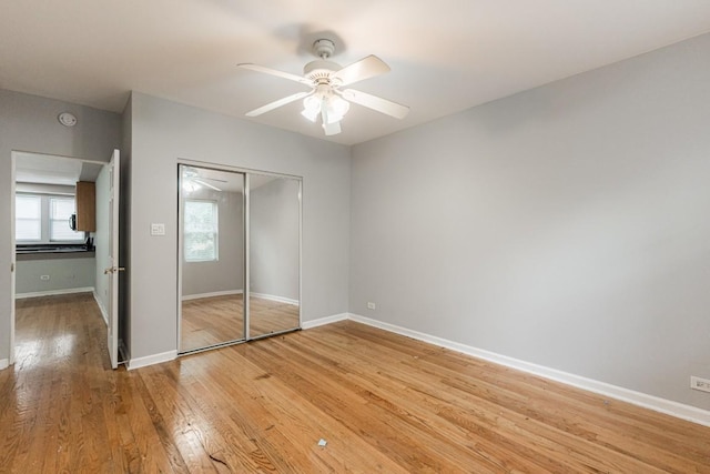 4008 W Nelson St Unit 8A, Chicago, IL 60641 - unfurnished bedroom with light wood finished floors, a closet, and ceiling fan