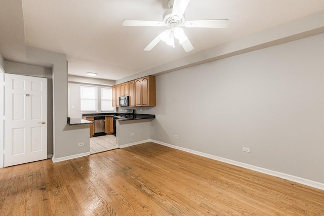4008 W Nelson St Unit 8A, Chicago, IL 60641 - kitchen with dark countertops, gas range oven, light wood-type flooring, ceiling fan, and stainless steel dishwasher