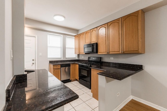 4008 W Nelson St Unit 8A, Chicago, IL 60641 - kitchen with black appliances, dark stone counters, and a peninsula