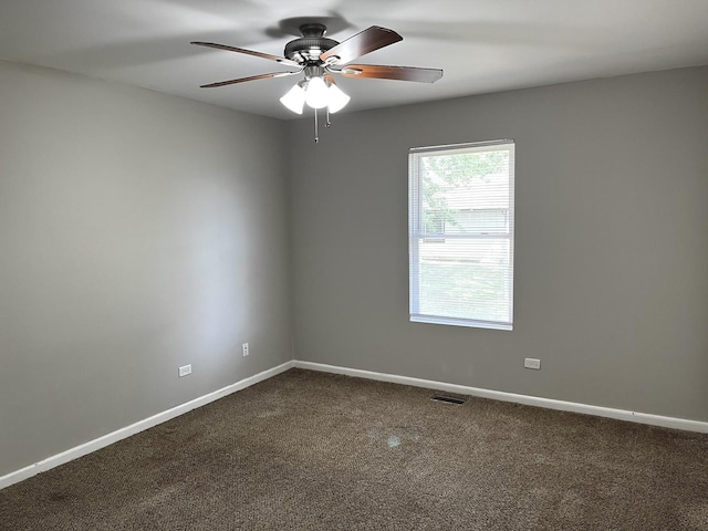 1244 Harvest Ln, University Park, IL 60484 - spare room with dark carpet and ceiling fan