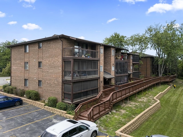 15141 Quail Hollow Dr Unit 106, Orland Park, IL 60462 - view of apartment building / complex featuring uncovered parking and stairway