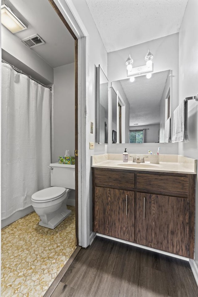 15141 Quail Hollow Dr Unit 106, Orland Park, IL 60462 - full bathroom with wood finished floors, vanity, a textured ceiling, and a shower with curtain