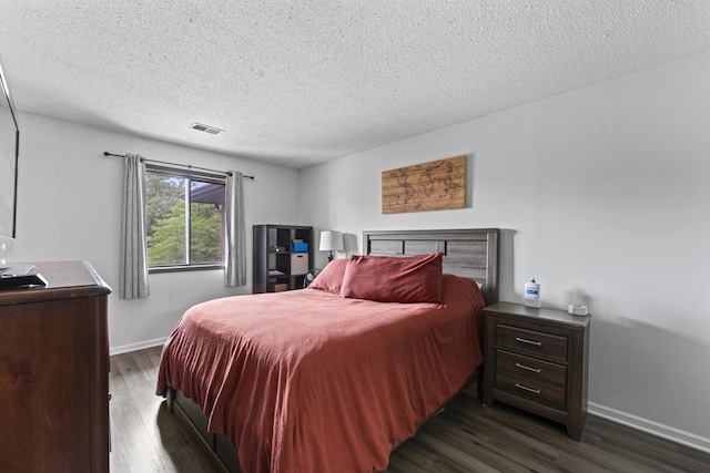 15141 Quail Hollow Dr Unit 106, Orland Park, IL 60462 - bedroom featuring dark wood finished floors and a textured ceiling