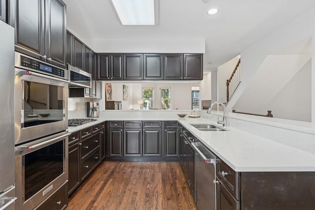 250 W Scott St Unit C, Chicago, IL 60610 - kitchen with appliances with stainless steel finishes, dark wood finished floors, light countertops, dark brown cabinetry, and recessed lighting