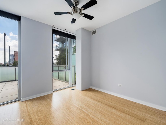 659 W Randolph St Unit 421, Chicago, IL 60661 - spare room with wood finished floors, floor to ceiling windows, plenty of natural light, and a ceiling fan