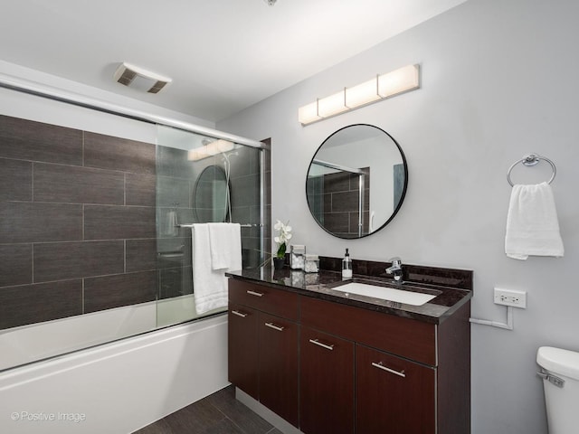 659 W Randolph St Unit 421, Chicago, IL 60661 - bathroom featuring vanity, combined bath / shower with glass door, and wood finished floors