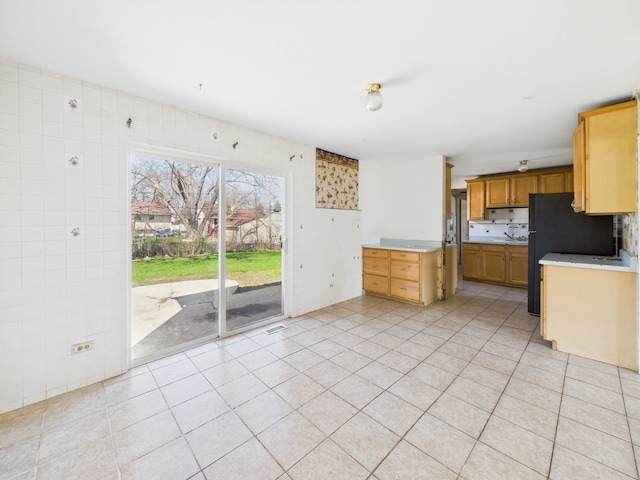 426 Norton Ave, Glendale Heights, IL 60139 - kitchen featuring light countertops, light tile patterned floors, and freestanding refrigerator