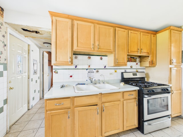 426 Norton Ave, Glendale Heights, IL 60139 - kitchen featuring stainless steel range with gas stovetop, light countertops, light tile patterned floors, and tasteful backsplash