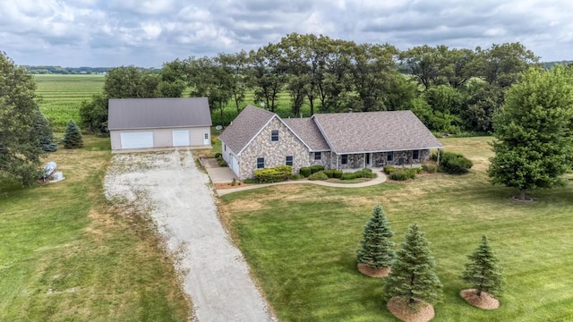 12571 W 3000 N Rd, Bonfield, IL 60913 - view of front of home featuring stone siding, a front yard, an outbuilding, covered porch, and a garage