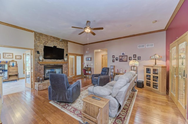 12571 W 3000 N Rd, Bonfield, IL 60913 - living room with french doors, a ceiling fan, light wood-style floors, a fireplace, and ornamental molding