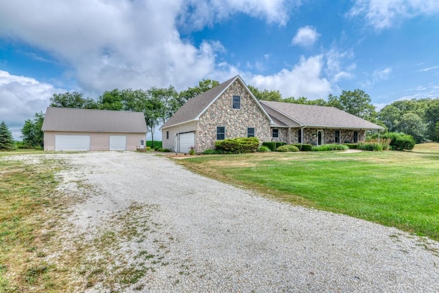 12571 W 3000 N Rd, Bonfield, IL 60913 - single story home with stone siding, a detached garage, and a front lawn