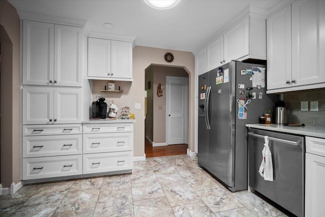 204 Collins Dr, Normal, IL 61761 - kitchen featuring appliances with stainless steel finishes, arched walkways, and light countertops