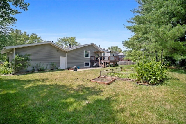 204 Collins Dr, Normal, IL 61761 - view of grassy yard featuring a vegetable garden and a wooden deck