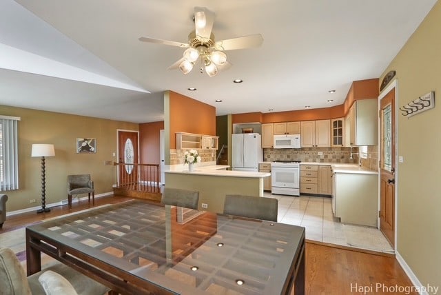 8308 W Leland Ave, Norridge, IL 60706 - dining area with ceiling fan, light wood-style flooring, and vaulted ceiling