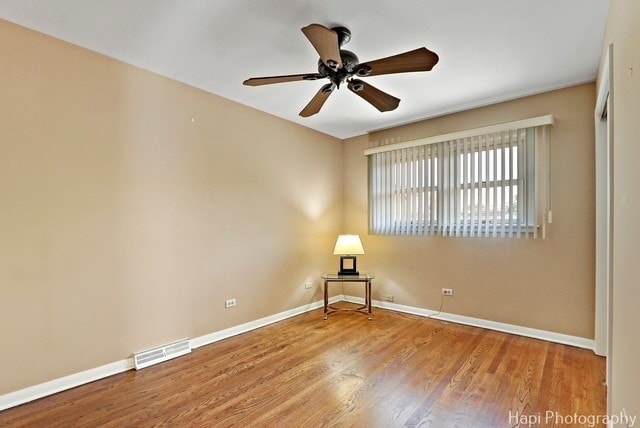 8308 W Leland Ave, Norridge, IL 60706 - empty room with a ceiling fan and wood finished floors