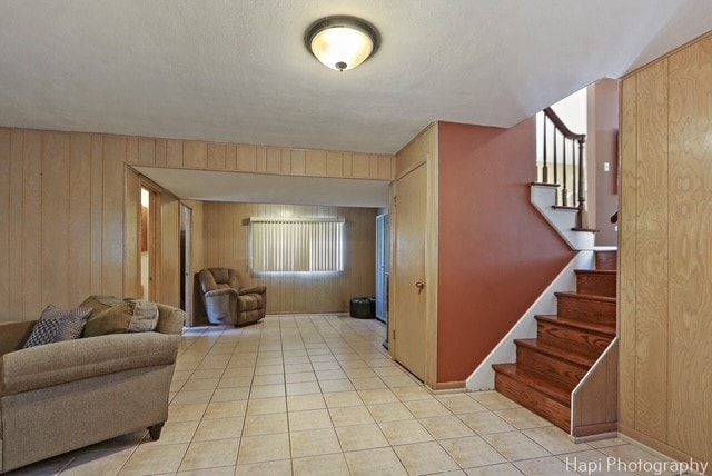 8308 W Leland Ave, Norridge, IL 60706 - living area featuring wood walls, stairs, and light tile patterned floors