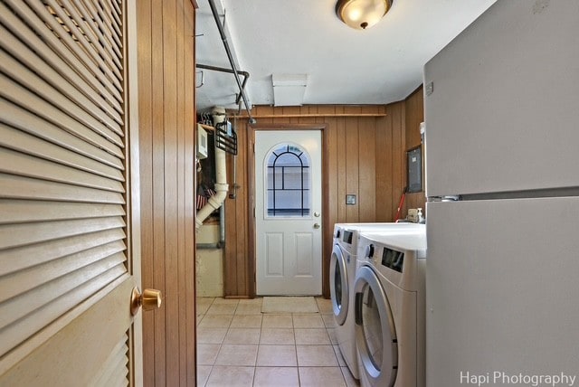 8308 W Leland Ave, Norridge, IL 60706 - laundry room featuring washing machine and dryer, light tile patterned floors, and wood walls