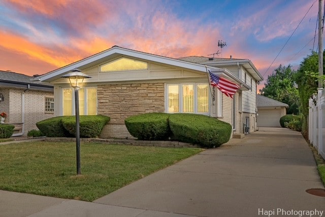 8308 W Leland Ave, Norridge, IL 60706 - view of front of home featuring stone siding, a lawn, and a garage