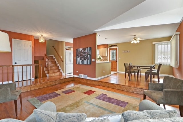 8308 W Leland Ave, Norridge, IL 60706 - living room featuring wood finished floors, stairway, and a ceiling fan
