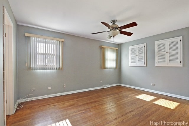 8308 W Leland Ave, Norridge, IL 60706 - empty room with wood finished floors and ceiling fan