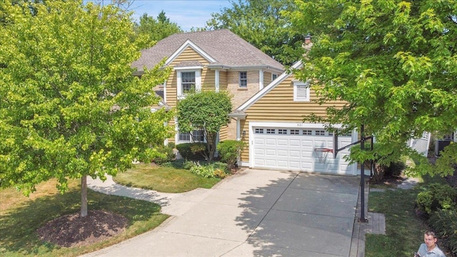 531 N Easy St, Palatine, IL 60067 - view of front of home featuring concrete driveway, an attached garage, and a chimney