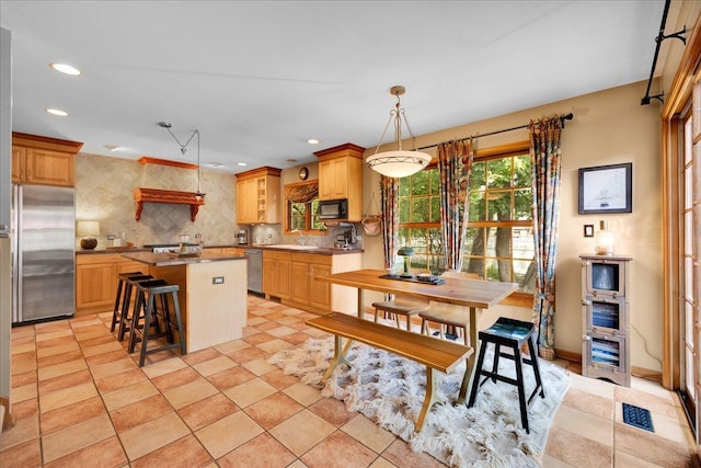 531 N Easy St, Palatine, IL 60067 - kitchen with appliances with stainless steel finishes, backsplash, a kitchen island, recessed lighting, and a breakfast bar
