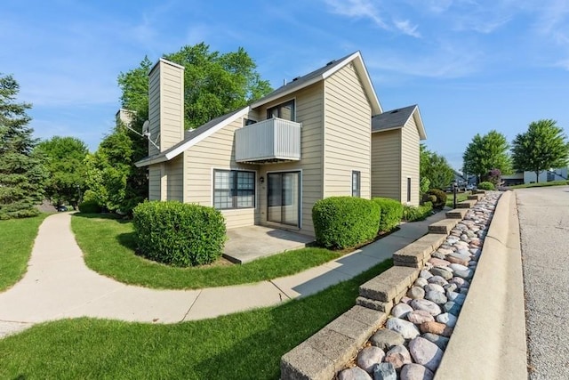 758 Sizer Rd, Gurnee, IL 60031 - view of side of property with a balcony, a chimney, and a patio