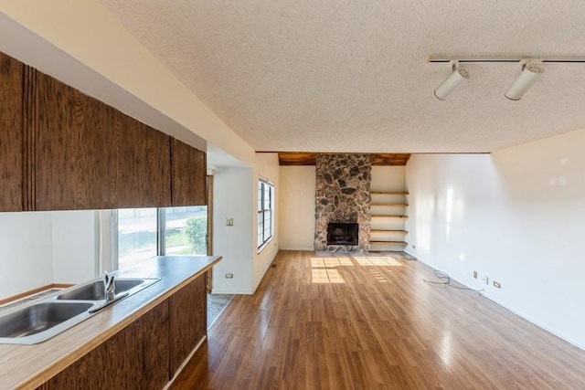 758 Sizer Rd, Gurnee, IL 60031 - unfurnished living room featuring a textured ceiling, wood finished floors, and a fireplace