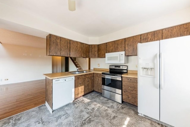 758 Sizer Rd, Gurnee, IL 60031 - kitchen featuring white appliances, a peninsula, light countertops, and brown cabinets