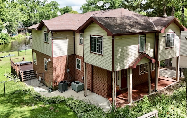236 Forest Dr, Island Lake, IL 60042 - back of house with a patio area, brick siding, roof with shingles, and a water view