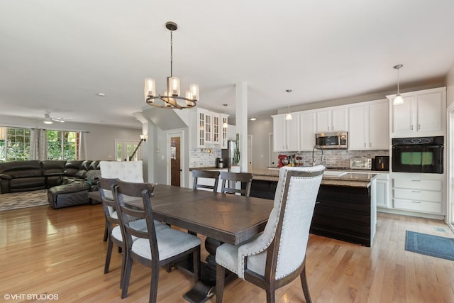 236 Forest Dr, Island Lake, IL 60042 - dining space featuring light wood-style floors, ceiling fan, and a chandelier