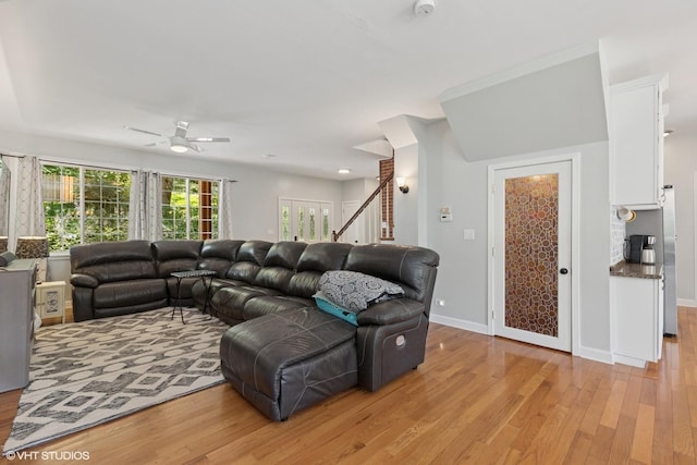 236 Forest Dr, Island Lake, IL 60042 - living area with light wood-style flooring, a ceiling fan, and stairs