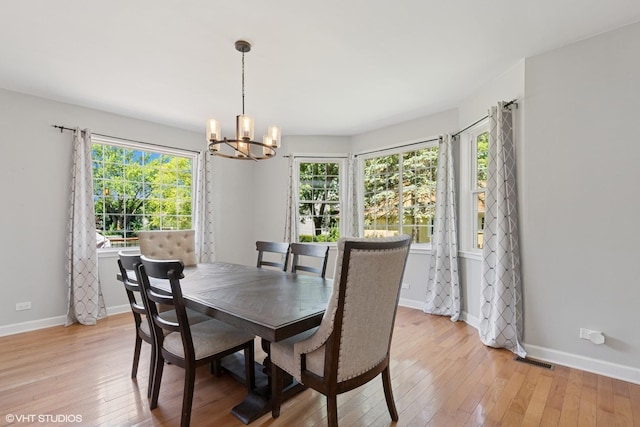 236 Forest Dr, Island Lake, IL 60042 - dining area featuring a chandelier, light wood-style floors, and healthy amount of natural light