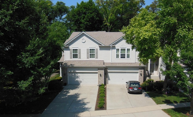 1420 Yellowstone Dr, Streamwood, IL 60107 - view of front of house with an attached garage, driveway, a shingled roof, and brick siding