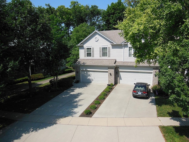 1420 Yellowstone Dr, Streamwood, IL 60107 - view of front facade with an attached garage, concrete driveway, a shingled roof, and brick siding