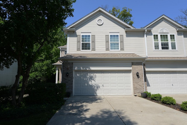 1420 Yellowstone Dr, Streamwood, IL 60107 - view of front of house featuring an attached garage, concrete driveway, and brick siding