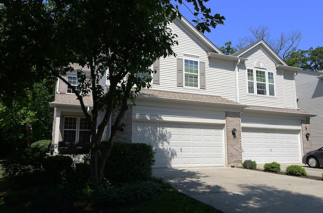 1420 Yellowstone Dr, Streamwood, IL 60107 - view of front of house with a garage, brick siding, and concrete driveway